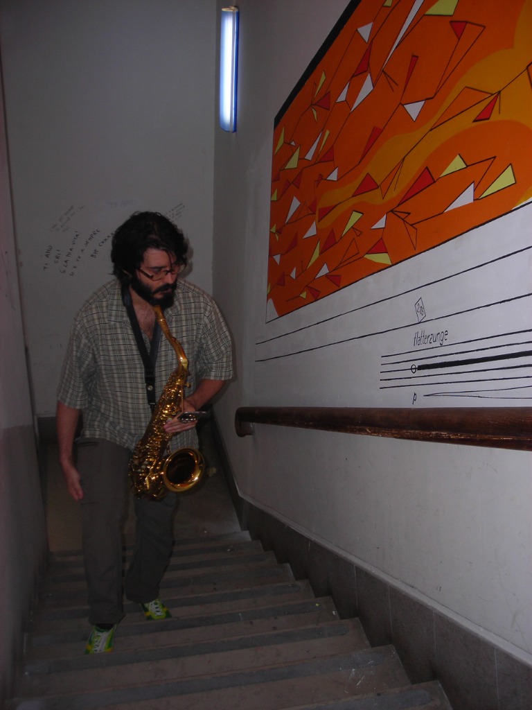 Performance of Walking Sax - Saxophonist on stairs