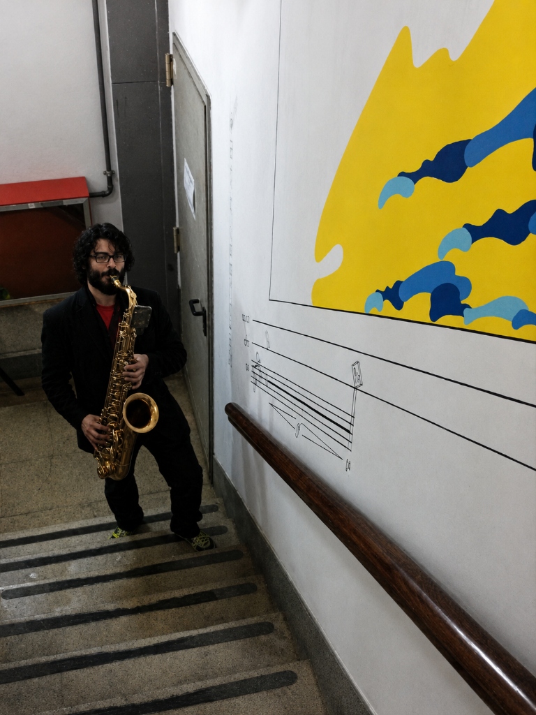 Performance of Walking Sax - Saxophonist playing close-up